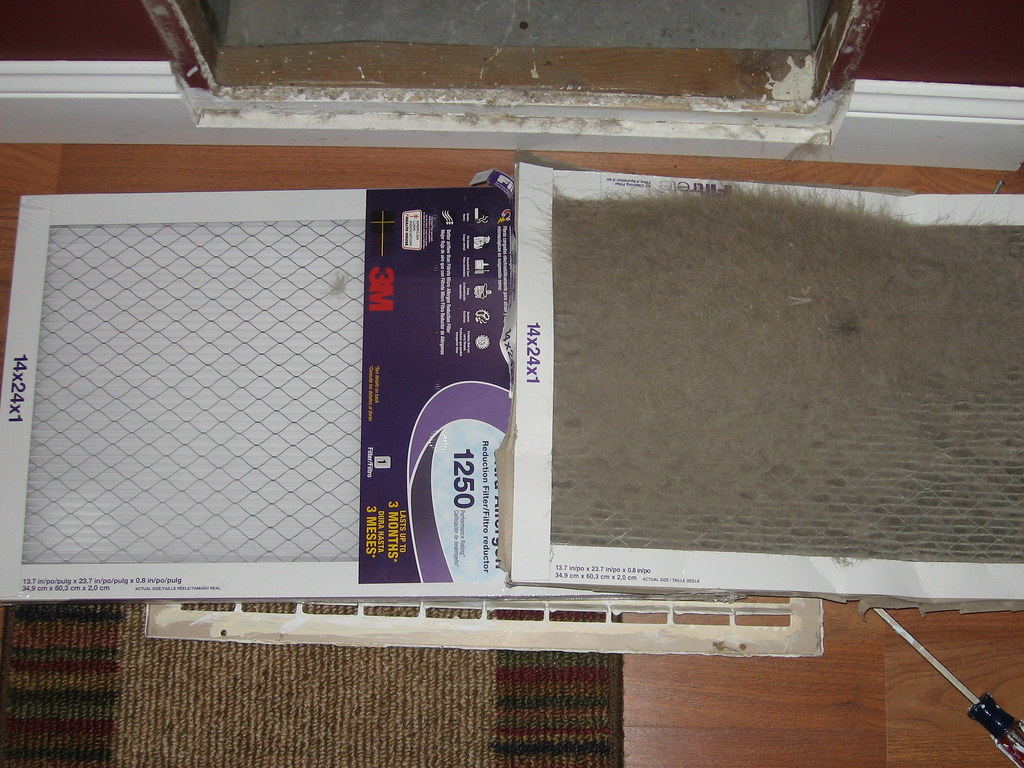 A new pleated air filter beside a dust-packed filter